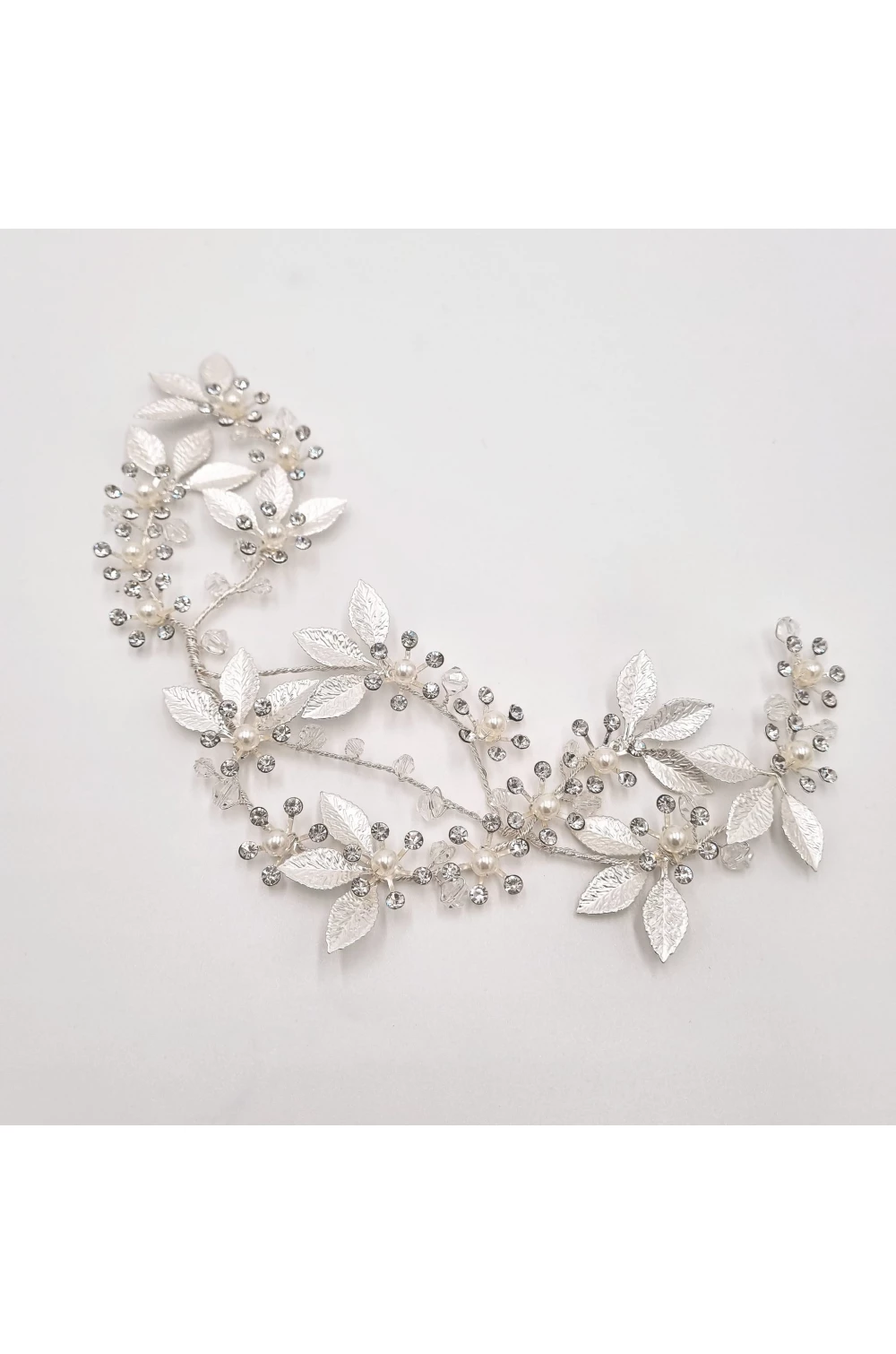 Strieborná ozdoba do vlasov pre nevestu s lístkami a kamienkovými kvietkami. Do boku účesu.